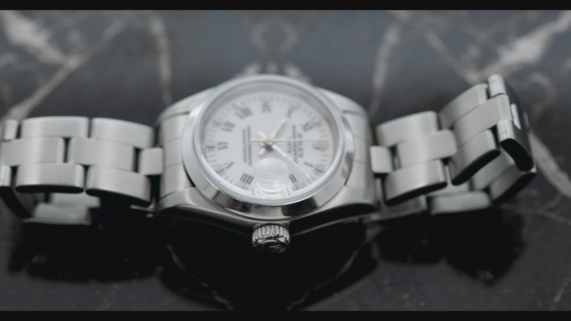 Rolex Date 26MM 69160 White Roman Dial Smooth Bezel Stainless Steel Oyster Bracelet