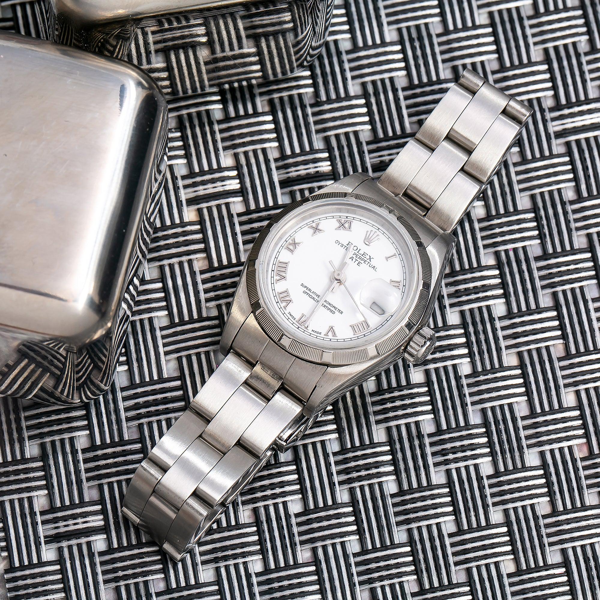 Rolex Date 26MM 79160 White Roman Dial Engine Turned Bezel Stainless Steel Oyster Bracelet